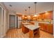 Modern kitchen featuring wooden cabinets, stainless steel appliances, and a convenient island, perfect for cooking at 2613 W Queensbury Rd, Muncie, IN 47304