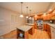 Well-lit kitchen with wood cabinets, stainless steel appliances, and a functional center island at 2613 W Queensbury Rd, Muncie, IN 47304