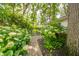 Beautiful landscaping with flowering bushes lining a stone pathway leading to the backyard at 2613 W Queensbury Rd, Muncie, IN 47304