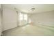 Cozy living room with natural light, wall paneling, and neutral walls, providing a comfortable and inviting space at 2613 W Queensbury Rd, Muncie, IN 47304
