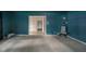 Spacious living room with a large window, light carpet, and an open doorway, creating a bright and airy atmosphere at 2613 W Queensbury Rd, Muncie, IN 47304