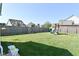 Fenced backyard with a lush lawn and a playset for outdoor fun at 2734 Chalbury Dr, Plainfield, IN 46168