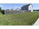 Expansive backyard featuring a wooden fence and lush green grass at 2734 Chalbury Dr, Plainfield, IN 46168