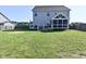 Large backyard with a screened-in porch and a well-maintained lawn at 2734 Chalbury Dr, Plainfield, IN 46168