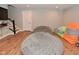 Finished basement rec room with soft lighting, wood-look flooring, and a staircase at 2734 Chalbury Dr, Plainfield, IN 46168