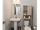 This powder room features a pedestal sink and storage space above the toilet at 2734 Chalbury Dr, Plainfield, IN 46168