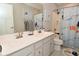 Bright bathroom with double sink vanity, white cabinets, and a shower with themed shower curtain at 2734 Chalbury Dr, Plainfield, IN 46168