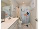 Bright bathroom features a white vanity, shower with fun fish curtain and kid-friendly decor at 2734 Chalbury Dr, Plainfield, IN 46168