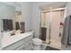 Bathroom features vanity, toilet, glass shower and neutral colored wall paint at 2734 Chalbury Dr, Plainfield, IN 46168
