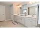 Bright bathroom with dual sinks, white cabinets, and tile flooring at 2734 Chalbury Dr, Plainfield, IN 46168