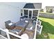 Cozy outdoor deck with comfortable seating, a fire pit table, and string lights at 2734 Chalbury Dr, Plainfield, IN 46168