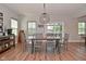 Charming dining area with a wooden table, stylish pendant light, and bright windows offering a cozy atmosphere at 2734 Chalbury Dr, Plainfield, IN 46168