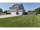 Large lawn and three-car garage enhance the curb appeal of this home at 2734 Chalbury Dr, Plainfield, IN 46168