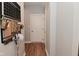 A hallway with hard surface flooring is accented with a Gathering calendar and storage at 2734 Chalbury Dr, Plainfield, IN 46168