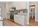 Beautiful kitchen with white cabinetry, granite countertops, stainless steel appliances, and stylish herringbone backsplash at 2734 Chalbury Dr, Plainfield, IN 46168