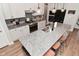 Spacious kitchen featuring granite countertops, seating, stainless steel appliances, and a herringbone backsplash at 2734 Chalbury Dr, Plainfield, IN 46168