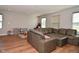 A large gray sectional couch accents the hard surface flooring in this bonus room at 2734 Chalbury Dr, Plainfield, IN 46168