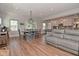 Inviting living space featuring a modern kitchen, dining area, and comfortable seating with wood flooring at 2734 Chalbury Dr, Plainfield, IN 46168