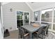 Relaxing screened porch with outdoor dining table on the rear of the home at 2734 Chalbury Dr, Plainfield, IN 46168