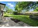 Large grassy backyard with mature trees and a small patio, perfect for outdoor entertaining at 2811 Beech Dr, Columbus, IN 47203