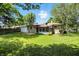 Lush backyard featuring a well-manicured lawn, mature trees, and a charming stone home exterior at 2811 Beech Dr, Columbus, IN 47203