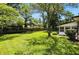 Expansive backyard with lush green grass, mature trees, and a well-maintained lawn, providing privacy at 2811 Beech Dr, Columbus, IN 47203