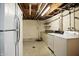Unfinished basement with exposed ceiling, painted walls and washer and dryer at 2811 Beech Dr, Columbus, IN 47203