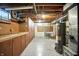 Unfinished basement with cabinets, utility access and water heater at 2811 Beech Dr, Columbus, IN 47203
