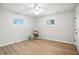 Bright bedroom featuring neutral walls, hardwood floors, and plenty of natural light from two windows at 2811 Beech Dr, Columbus, IN 47203