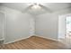 Bedroom featuring wood-look flooring, a ceiling fan, and an ensuite bathroom at 2811 Beech Dr, Columbus, IN 47203