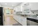 Well-lit kitchen with stainless steel appliances, granite countertops, and access to adjacent dining and living area at 2811 Beech Dr, Columbus, IN 47203