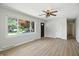 Bright living room featuring new floors, a ceiling fan and a large window offering lots of natural light at 2811 Beech Dr, Columbus, IN 47203