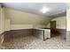 Attic featuring wood paneled walls and neutral toned carpet at 29 E Caven St, Indianapolis, IN 46225