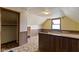 Attic with wood paneled walls, window, and closet at 29 E Caven St, Indianapolis, IN 46225