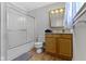Functional bathroom featuring a shower-tub combo and vanity with wood cabinet at 29 E Caven St, Indianapolis, IN 46225