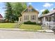 Charming home exterior with covered porch and mature trees at 29 E Caven St, Indianapolis, IN 46225