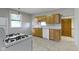 Functional kitchen with oak cabinets, white appliances, and easy access to hallway at 29 E Caven St, Indianapolis, IN 46225