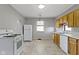 Bright kitchen featuring oak cabinets, white appliances, and an abundance of natural light at 29 E Caven St, Indianapolis, IN 46225