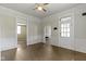 Sunlit living room boasts wood floors, white trim, and an entry door at 29 E Caven St, Indianapolis, IN 46225