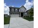 Beautiful two-story home featuring a two-car garage and a well-manicured lawn at 3068 Gibbert Ln, Westfield, IN 46074