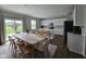 Open dining area with a view of the modern kitchen featuring white cabinets and an island at 3068 Gibbert Ln, Westfield, IN 46074