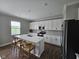 Modern kitchen featuring a large island with seating and stainless steel appliances at 3068 Gibbert Ln, Westfield, IN 46074