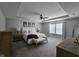 Spacious main bedroom featuring a tray ceiling, fan, bench, and large windows at 3068 Gibbert Ln, Westfield, IN 46074