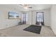 This bedroom features a ceiling fan, two windows, and television at 3341 Carica Dr, Indianapolis, IN 46203
