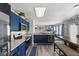 Bright kitchen features blue cabinetry, stainless steel appliances, and opens to the living room at 3341 Carica Dr, Indianapolis, IN 46203
