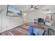 Cozy living room features a large TV, a ceiling fan, and a bright window at 3341 Carica Dr, Indianapolis, IN 46203