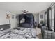 The main bedroom features a canopy bed, ceiling fan, and two lounge chairs at 3341 Carica Dr, Indianapolis, IN 46203