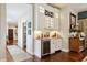 Elegant bar area with custom cabinetry, granite countertops, wine storage, and stylish decor at 3399 Nottinghill Blvd, Plainfield, IN 46168