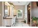 Bright bathroom with a large vanity, arched window, and tiled shower at 3399 Nottinghill Blvd, Plainfield, IN 46168