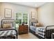 A charming bedroom features twin beds, natural light from the window and a rustic nightstand at 3399 Nottinghill Blvd, Plainfield, IN 46168